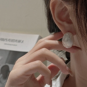 S925 sterling silver oval stud earrings with fine grid texture shown on model