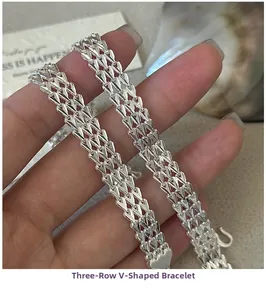Detailed close-up of a triple-row V-link silver bracelet with a polished finish