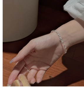Detailed close-up of a S925 sterling silver rope chain bracelet on a wrist