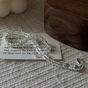 Minimalist S999 sterling silver woven chain bracelet with lobster clasp on jewelry box