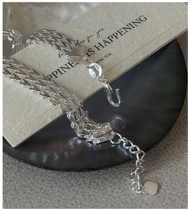 Close-up of S999 silver multi-row sparkling bracelet with lobster clasp and heart pendant