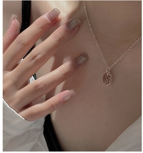Detail of S925 sterling silver necklace featuring an oval rutilated quartz pendant