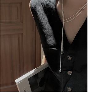 Long Y-shaped S925 sterling silver sweater chain with teardrop pendant on a V-neck model