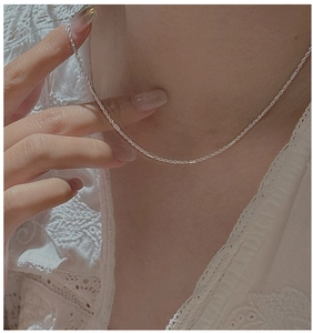Detailed view of an S925 sterling silver twisted rope chain necklace on a model