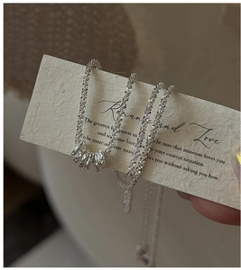 Macro view of S925 sterling silver necklace with textured rings and shimmering chain