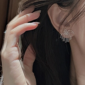 S925 sterling silver fringe tassel earrings with sparkling fireworks design on ear