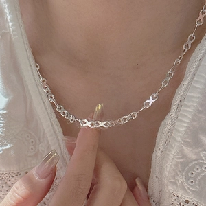 Minimalist S925 sterling silver necklace featuring infinity X-links on a female model