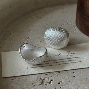 Minimalist S925 sterling silver stud earrings with brushed texture in a semi-round design