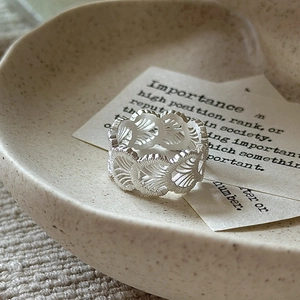 Minimalist S925 sterling silver lace texture ring with a matte finish on ceramic plate