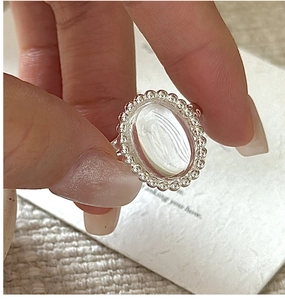 Detail of S925 sterling silver ring with oval white crystal and vintage beaded edge