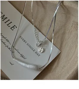 Macro detail of S925 sterling silver brushed pendant with snake chain and AG925 tag