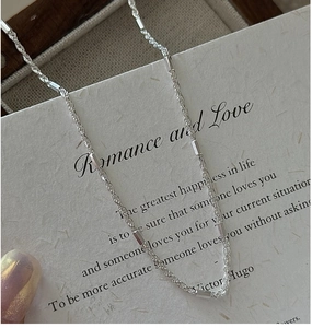 Detail of S925 sterling silver rope chain necklace with polished beads on vintage card