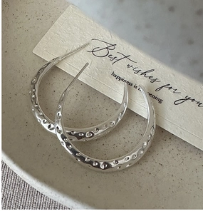 Close-up of S925 sterling silver hoop earrings with vintage hammered texture detail