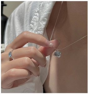 Close-up of S925 sterling silver jewelry set featuring light blue gemstone necklace and ring