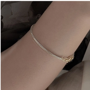 Detail of s925 silver two-tone snake bone bracelet with Italian craft and gold finish
