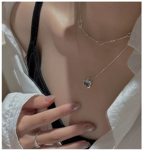 Detail of S925 silver layered necklaces with blue gemstone pendant and matching ring