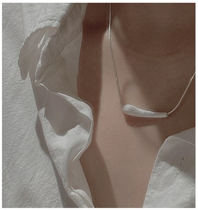 Detail of S925 sterling silver water drop pendant necklace with brushed texture on skin