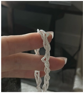 Close-up of S925 sterling silver multi-layer woven chain with intricate braided texture