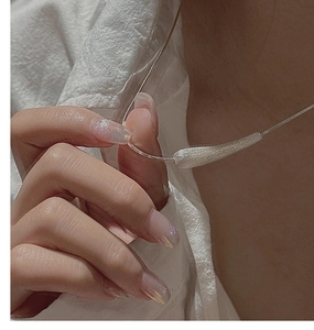 Detail of minimalist S925 sterling silver necklace with a brushed matte texture finish