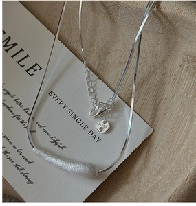 Detailed macro view of S925 sterling silver brushed pendant and Ag925 hallmark tag