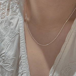 Minimalist S925 sterling silver twisted chain necklace worn on model neck