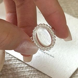 S925 sterling silver ring with oval white crystal and vintage beaded edge on model