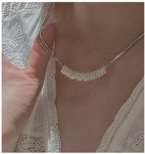 Close-up of S925 sterling silver twisted ring necklace on model with lace outfit