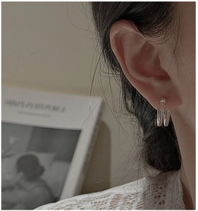 Close-up of minimalist S925 sterling silver double-layered round hoop earrings on model