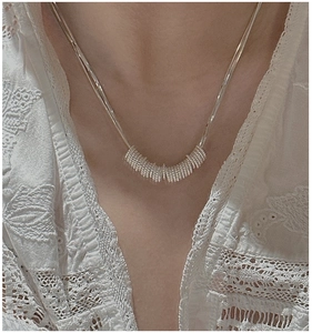 Detailed view of textured S925 sterling silver beaded rings on a minimalist chain necklace