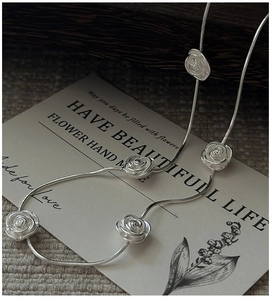 Close-up of S925 sterling silver rose necklace with detailed 3D floral pendant accents