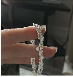 Close-up of S925 sterling silver multilayer woven cross chain bracelet detailing