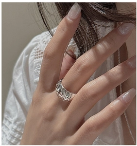 Detail of S925 sterling silver ring with textured folded pleats and modern wide band design
