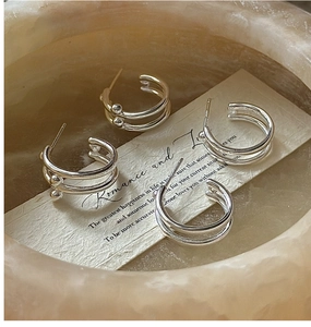 Detailed close-up of S925 sterling silver double hoop earrings with bead accents