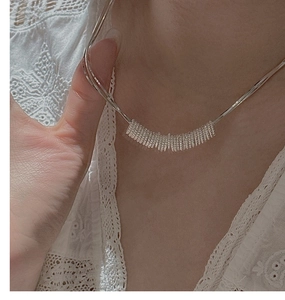 Detail of S925 sterling silver necklace featuring a spiral spring pendant on a snake chain