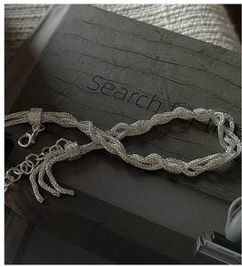 Detailed macro view of S925 silver multilayer braided chain bracelet with lobster clasp