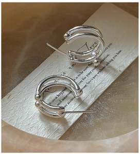 Detailed close-up of S925 sterling silver C-shape triple layer hoop earrings