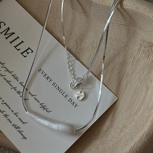 Minimalist S925 sterling silver brushed irregular bar necklace on a wooden tray