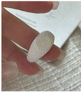 Close-up of S925 silver ring featuring a unique caviar texture and grainy metallic surface