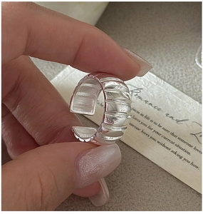Close-up of S925 sterling silver wide croissant ring with spiral textured polished finish