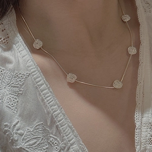 Minimalist S925 silver necklace featuring five delicate 3D carved roses on a thin chain