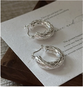 Close-up of S925 sterling silver hoop earrings with 3D embossed woven texture detail