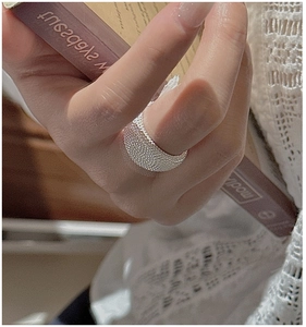 Detail of S925 sterling silver ring with beaded texture on model finger