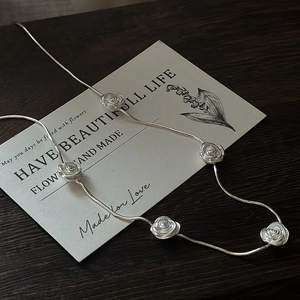 S925 silver rose necklace featuring five 3D floral charms on a sleek snake chain