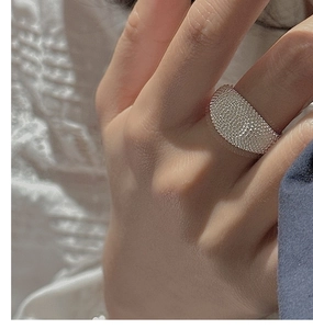 Macro shot of a wide S925 sterling silver ring with micro-bead textured finish on finger