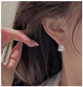 Detailed view of S925 sterling silver hoop earrings with unique pleated wave texture