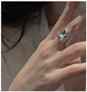 Detailed view of the S925 sterling silver irregular liquid metal ring worn on hand