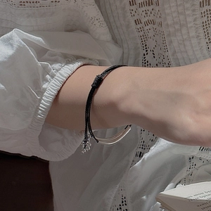 Minimalist S925 sterling silver triple-layer woven bracelet on a model's wrist