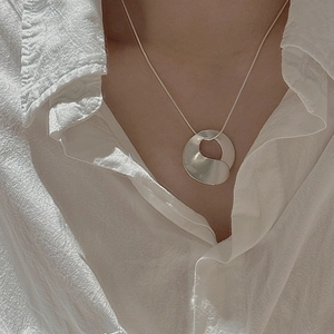S925 sterling silver necklace featuring an abstract irregular round pendant on a model