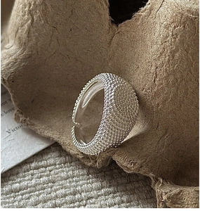 Macro shot of S925 sterling silver ring with beaded texture and adjustable open band