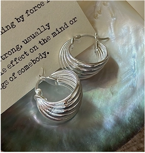 Close-up of S925 sterling silver hoop earrings with multi-layer wavy textured design